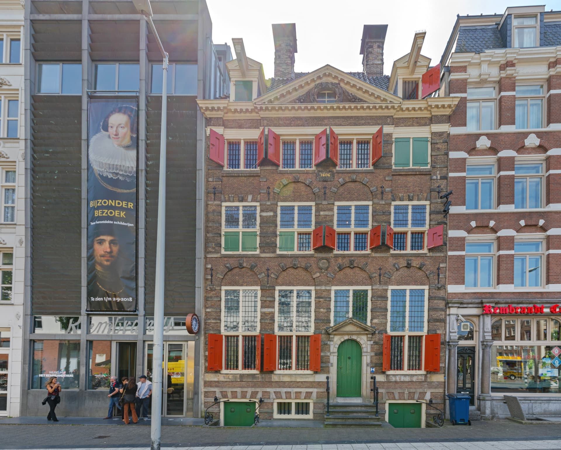 The facade of the Rembrandt House in Amsterdam dated 1606, with red and green shutters and a green door