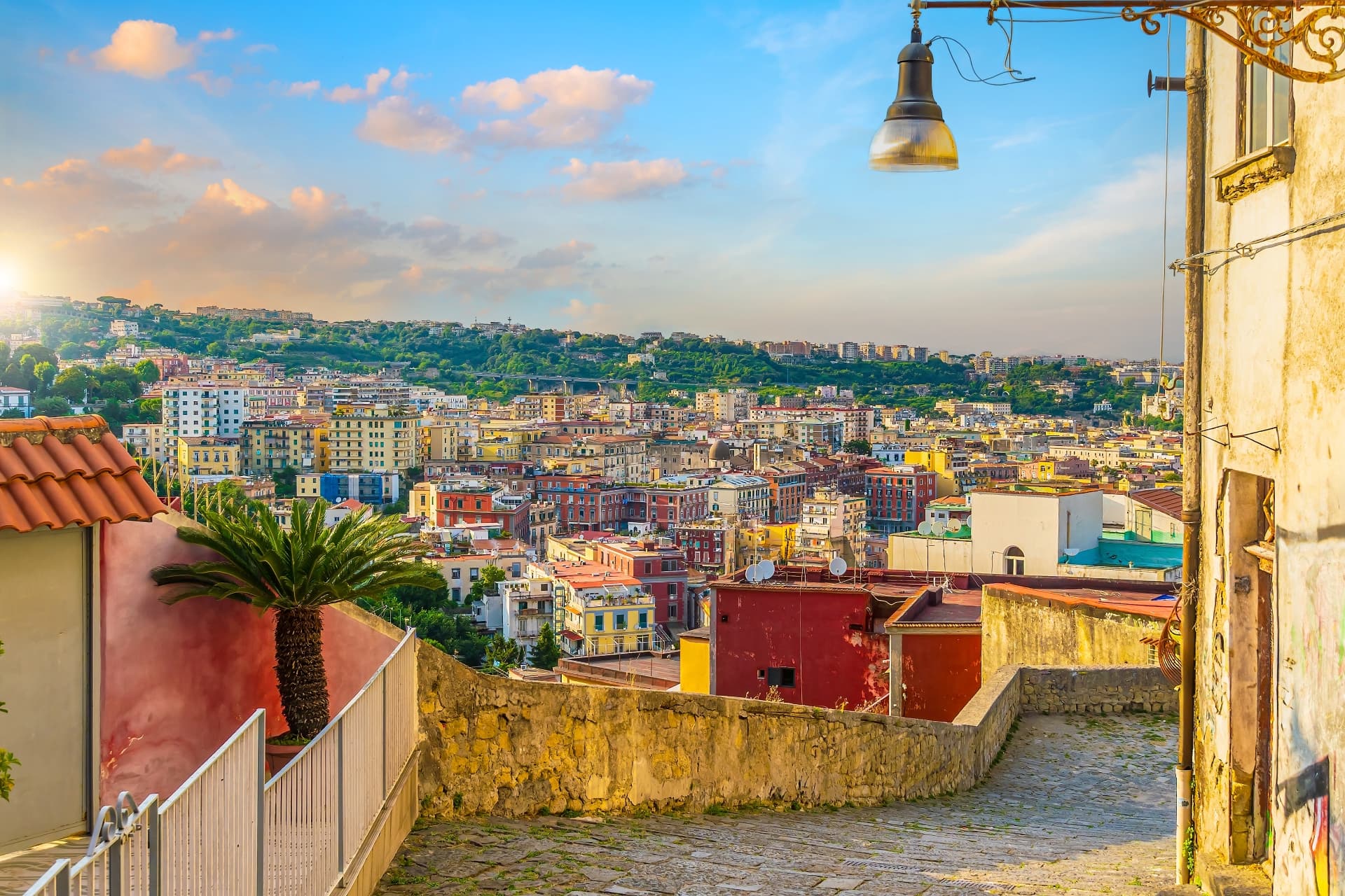 View over the colourful hillside neighbourhoods of Naples from a stepped lane