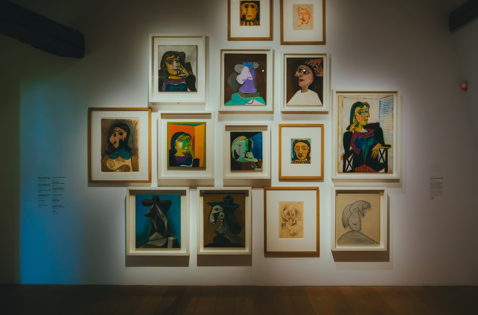 A gallery wall hung with a dense arrangement of framed Picasso portraits in the Musée Picasso Paris