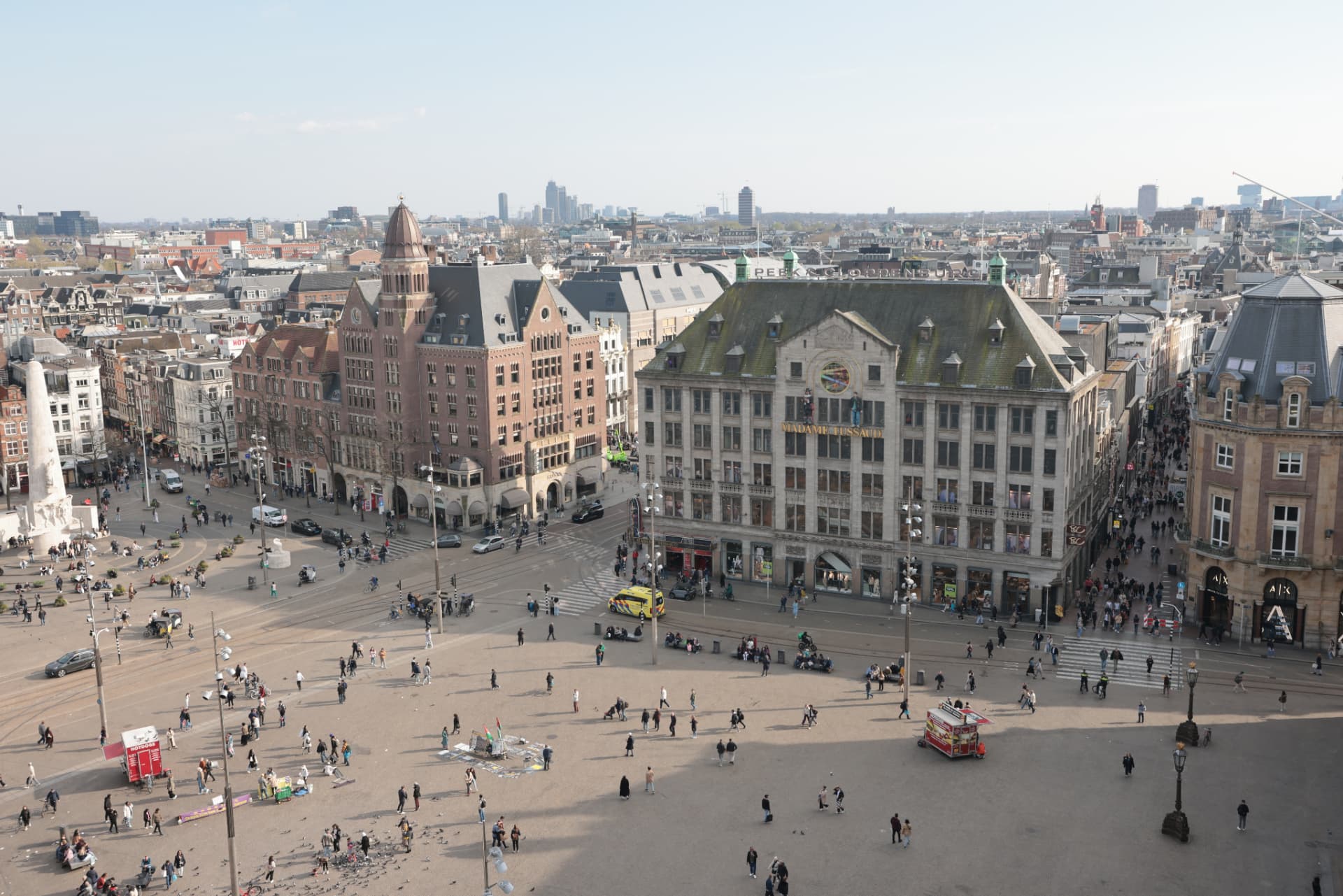 Aerial view over Dam Square in Amsterdam with Madame Tussauds, the National Monument and the city skyline