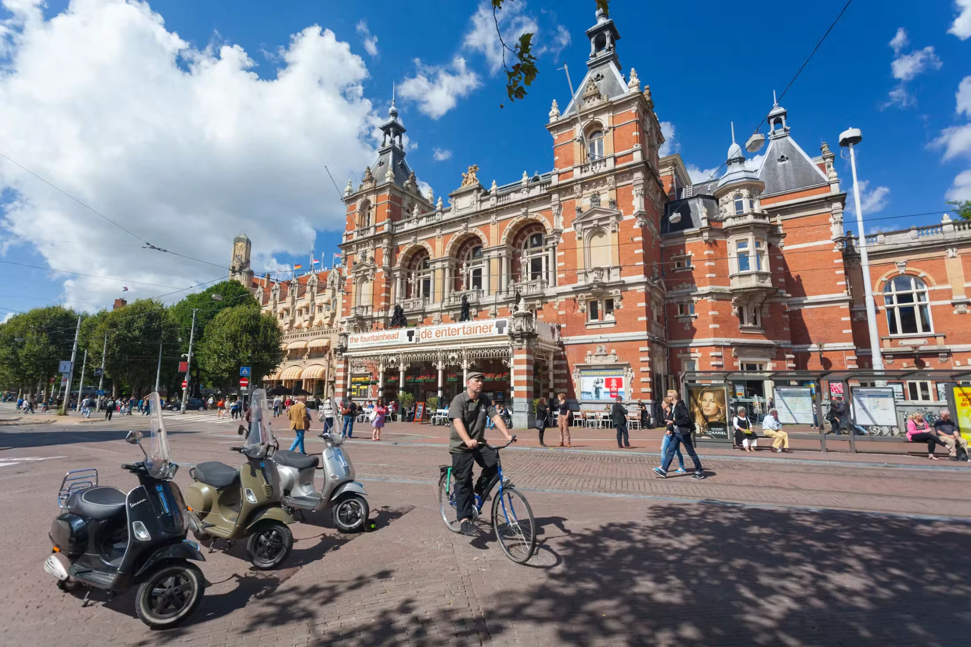 The Stadsschouwburg theatre on Leidseplein, Amsterdam, with café terraces in front of the red-brick facade