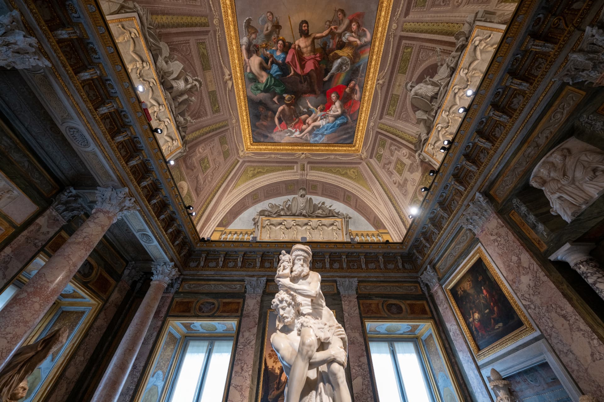 White marble sculpture beneath a painted Borghese Gallery ceiling