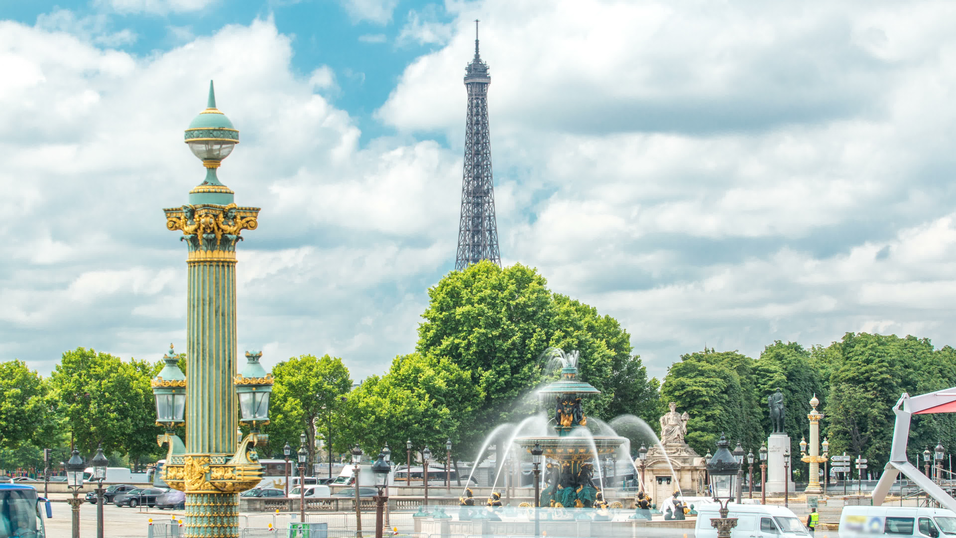 Green and gold Concorde column and fountain with the Eiffel Tower visible in the distance
