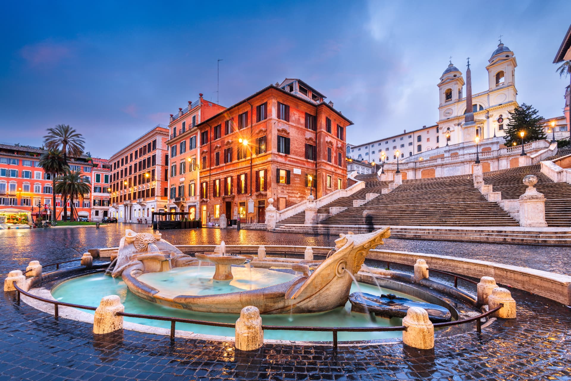 Barcaccia fountain with the Spanish Steps and neighbouring houses in evening light