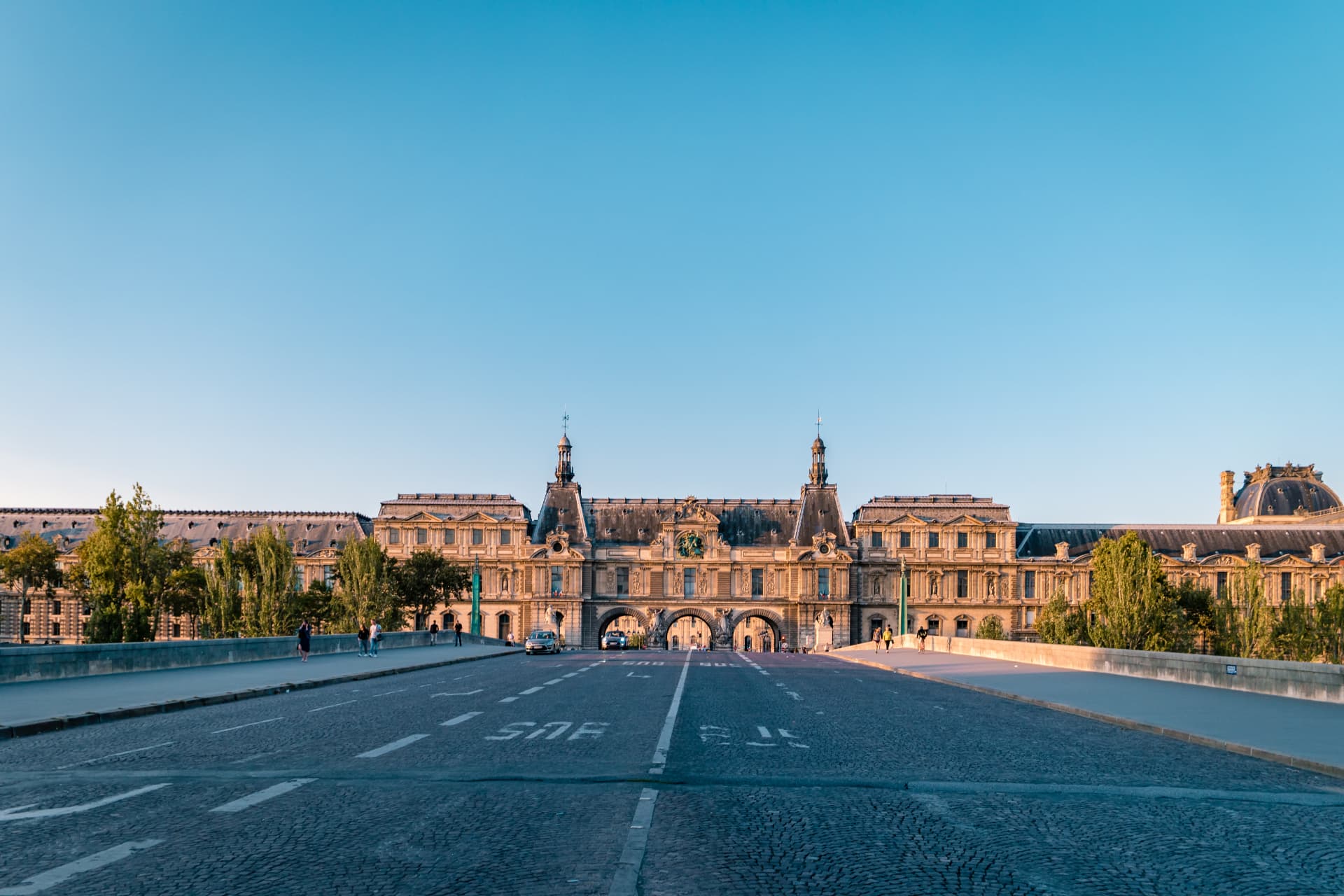 Arc de Triomphe du Carrousel and Louvre complex seen from a road near the Tuileries