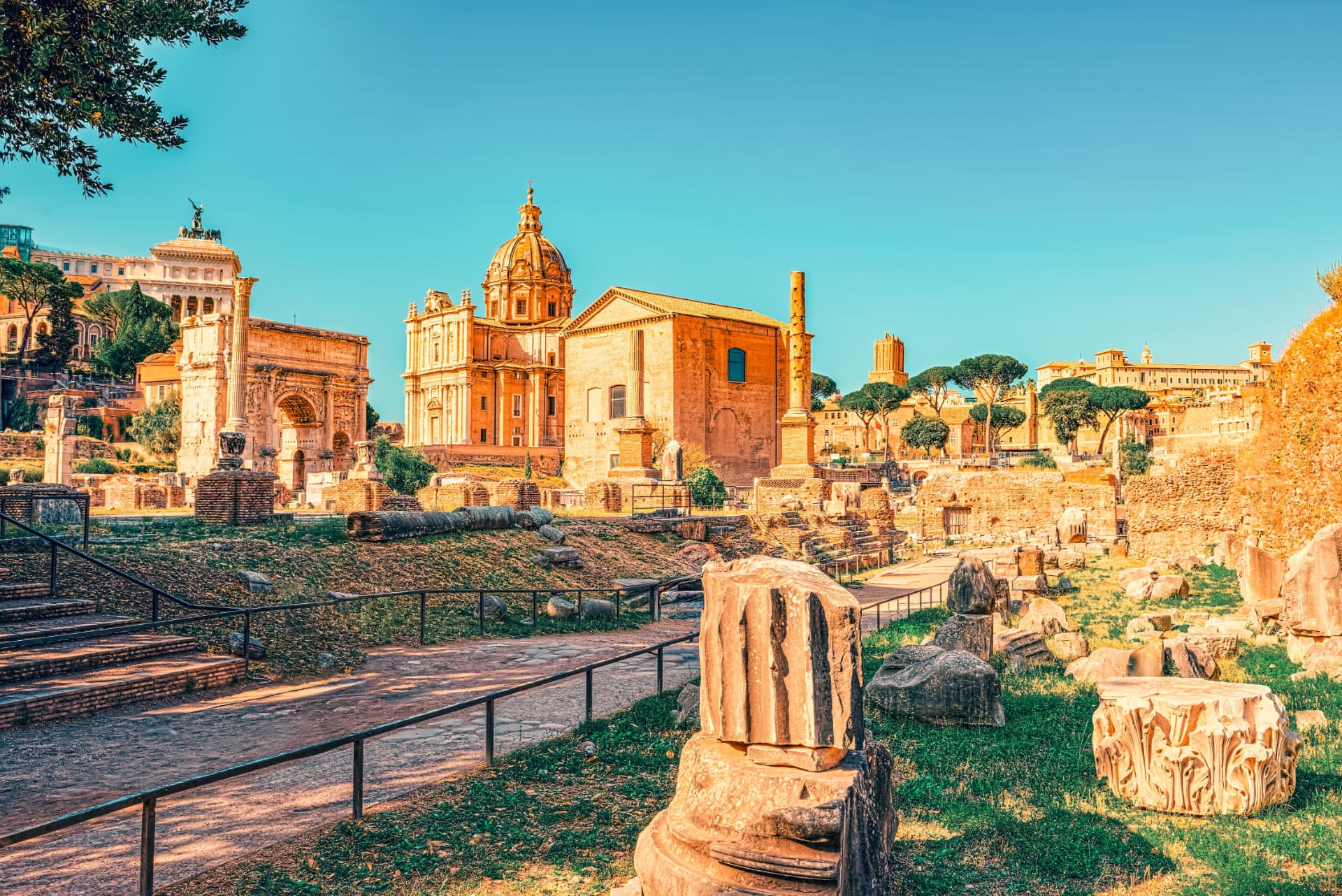 Curia Julia beside the Arch of Septimius Severus seen across ruins of the Roman Forum