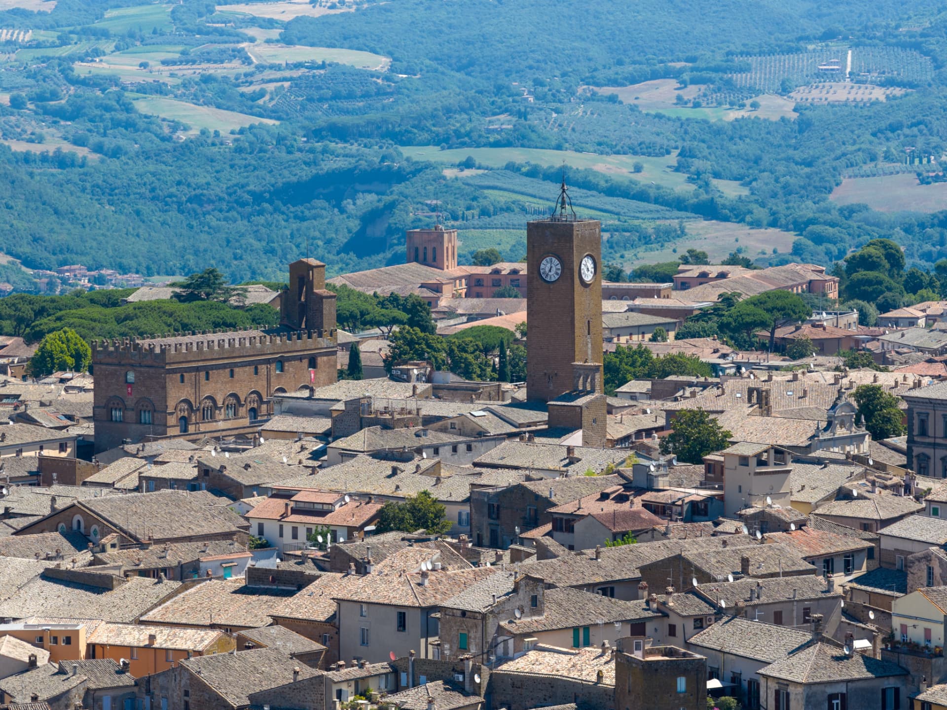 Orvieto's rooftops and the Torre del Moro clock tower with the Umbrian hills behind