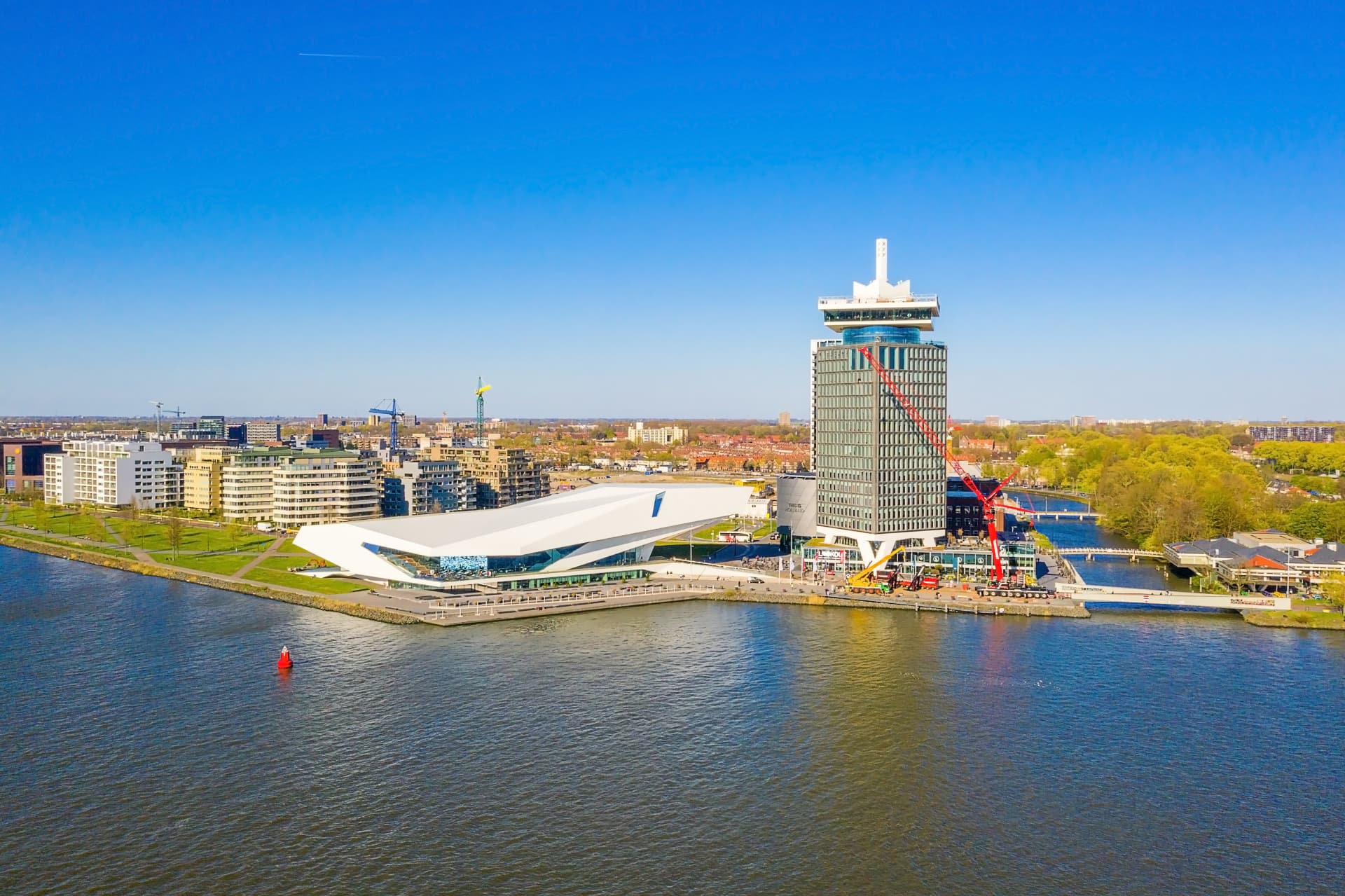 Aerial view of the white Eye Filmmuseum and the A'DAM Tower on the north bank of the IJ in Amsterdam