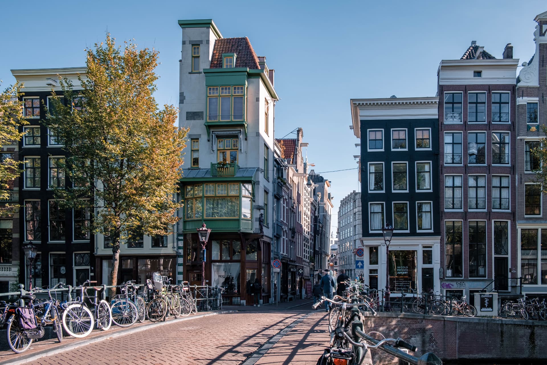 Gabled canal houses and bicycles on a bridge in the 9 Streets district of Amsterdam on a sunny day