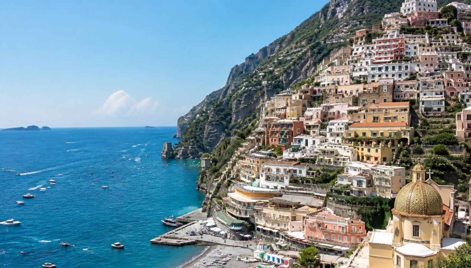 Pastel houses stacked above the sea on the Amalfi Coast