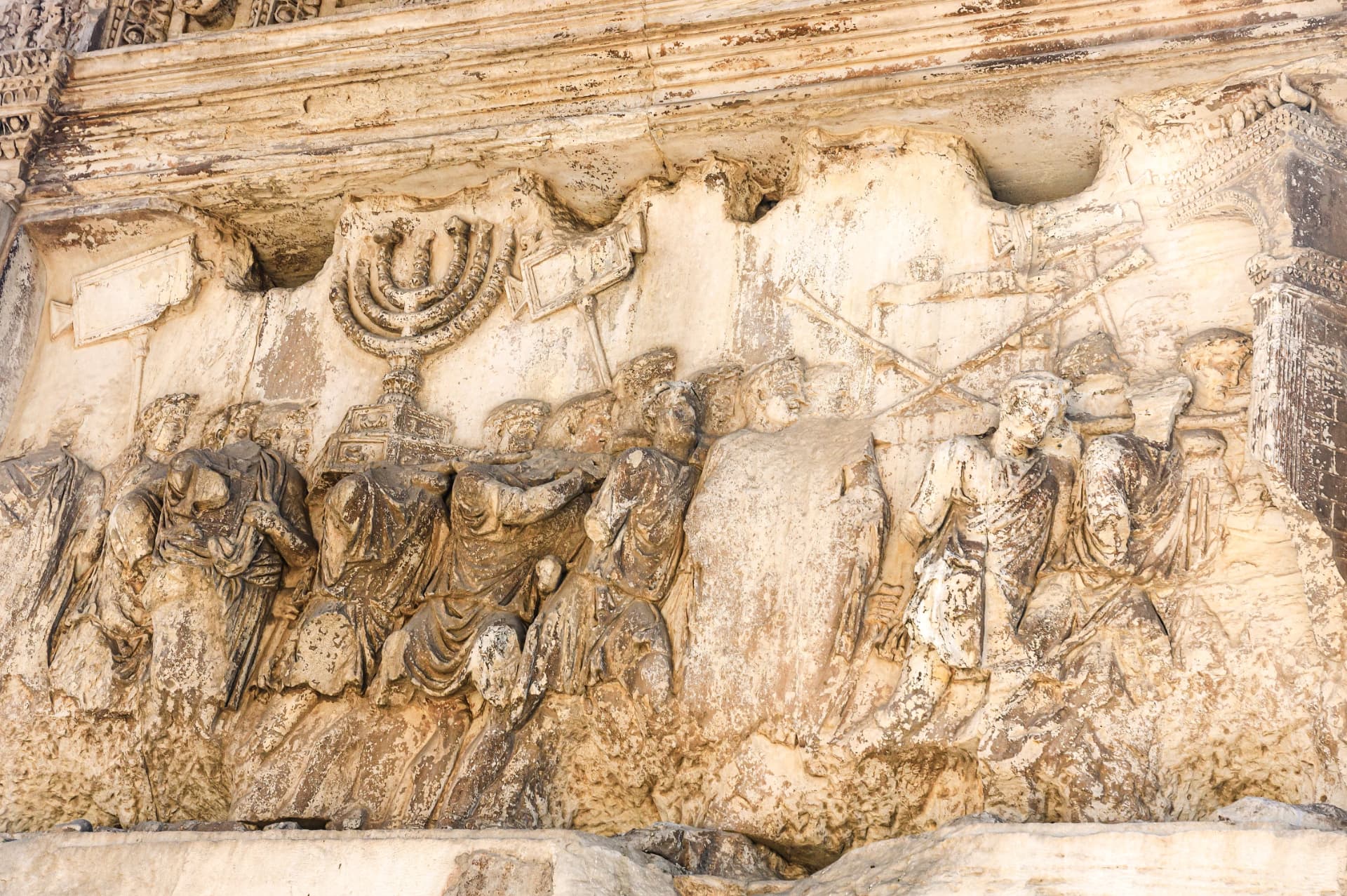 The spoils of Jerusalem relief inside the Arch of Titus — Roman soldiers carry the seven-branched menorah of the Second Temple through a triumphal gate