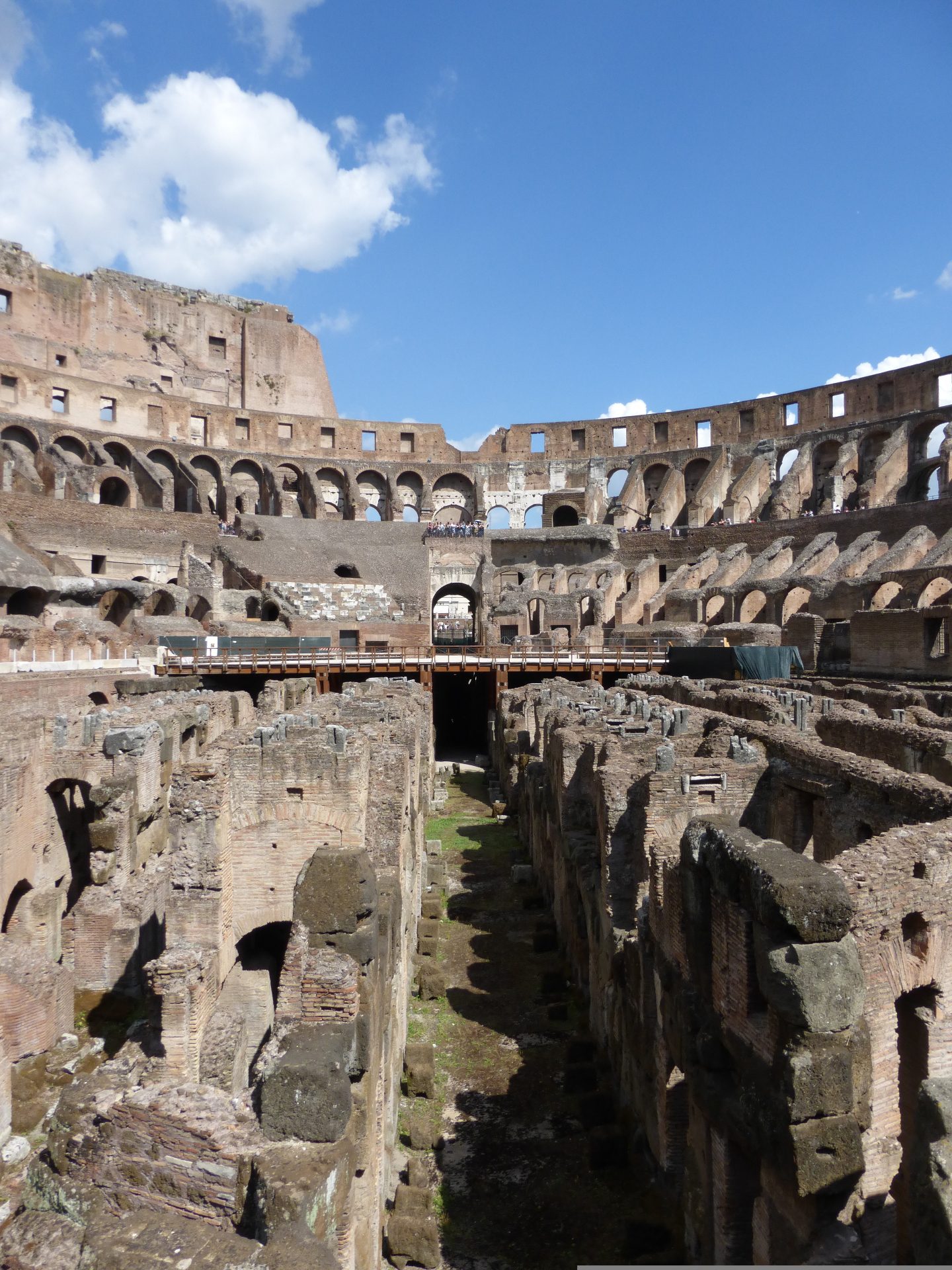 Vaulted ancient Roman brick corridors lit for visitors