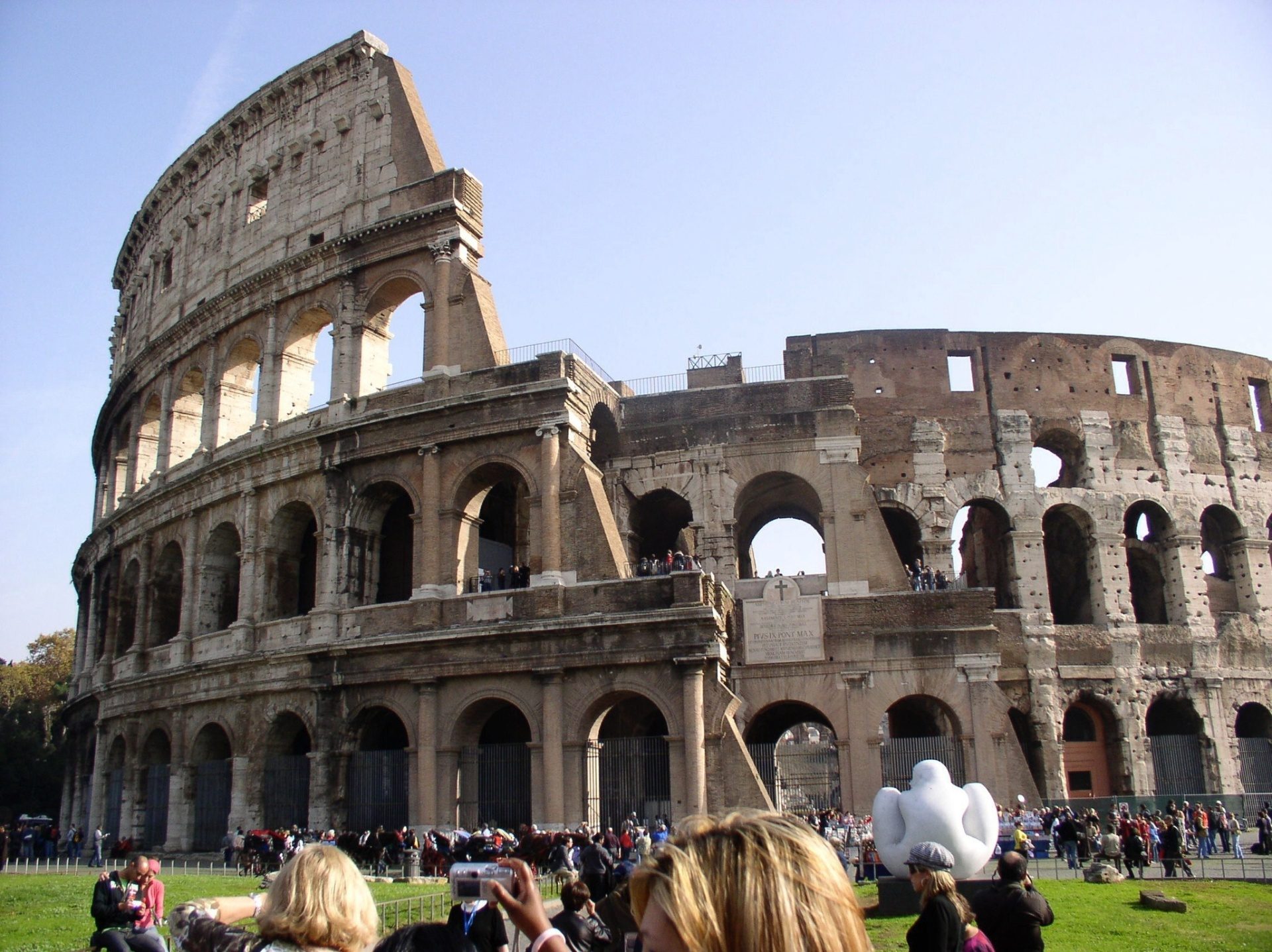 Visitors approaching the Colosseum ticket gates during a busy afternoon