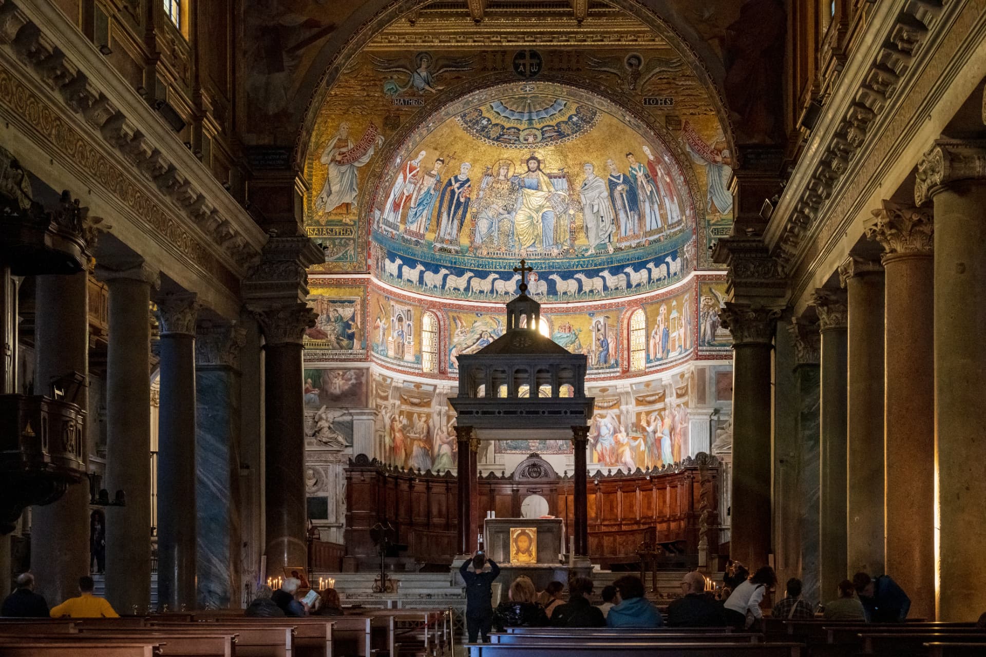 The 12th-century gold apse mosaic of Santa Maria in Trastevere showing Christ and the Virgin enthroned together with saints and a frieze of lambs below