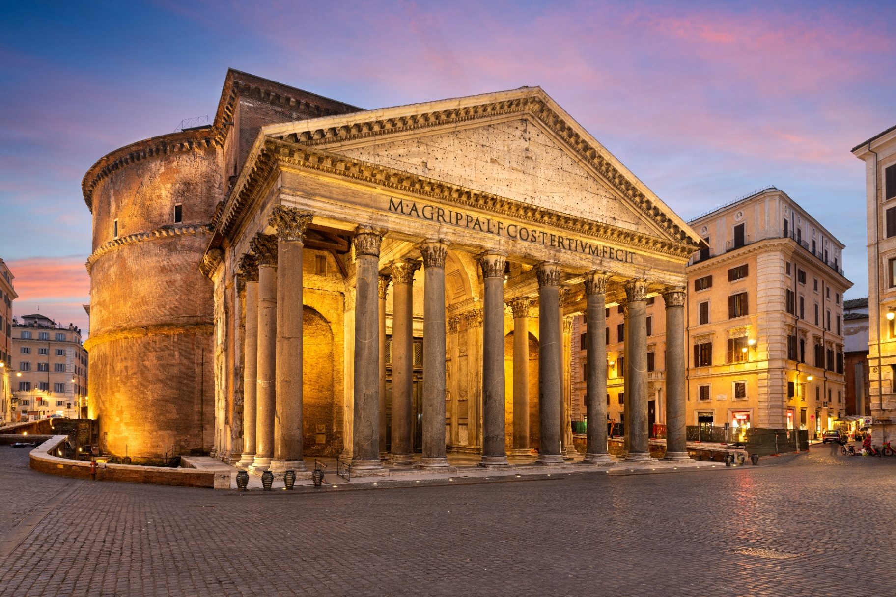 Pantheon Rome facade and rotunda glowing at sunset under a pink and violet sky in Piazza della Rotonda