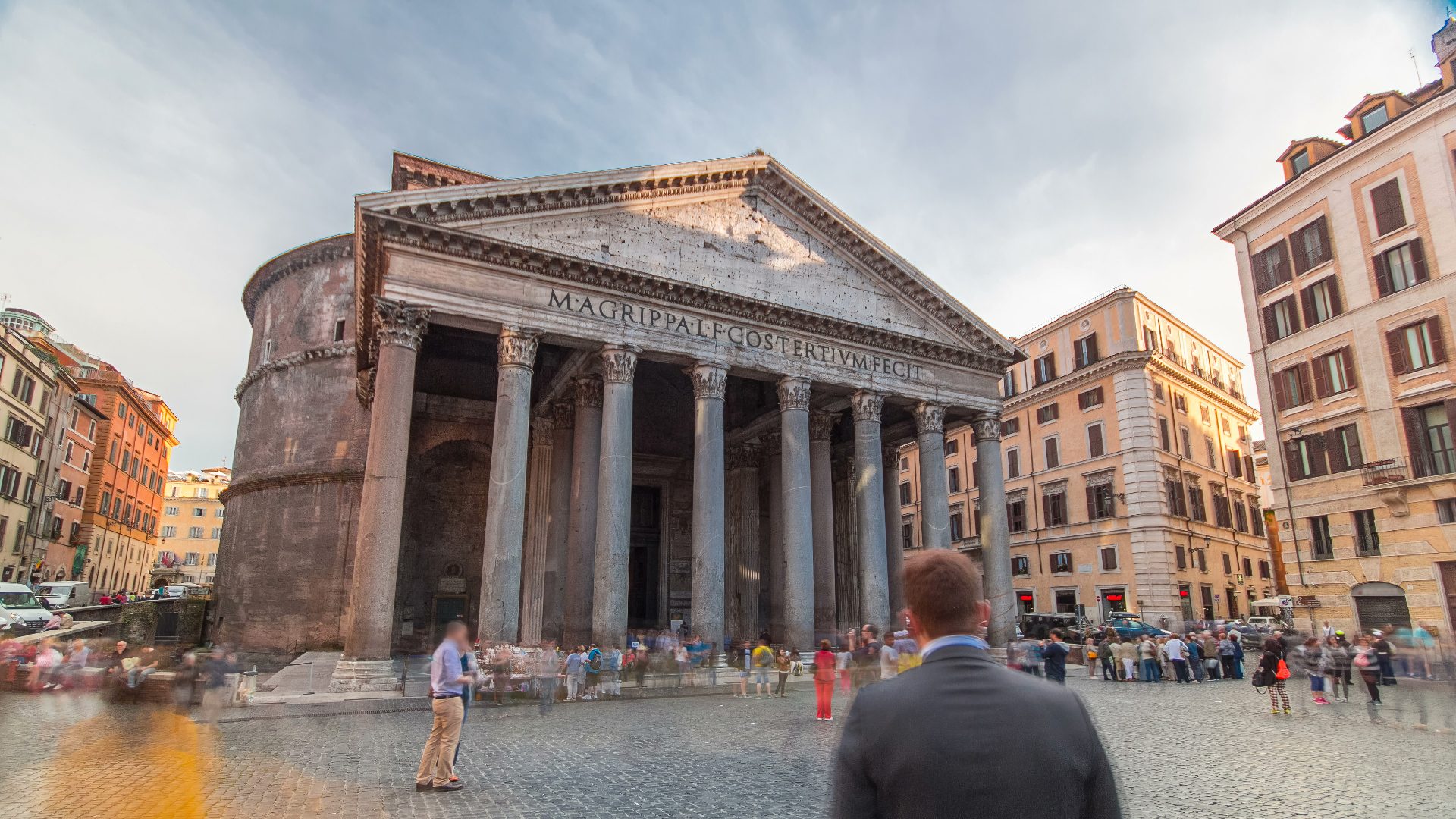 Pantheon Rome portico and pediment with crowds of visitors gathered in the piazza during the day