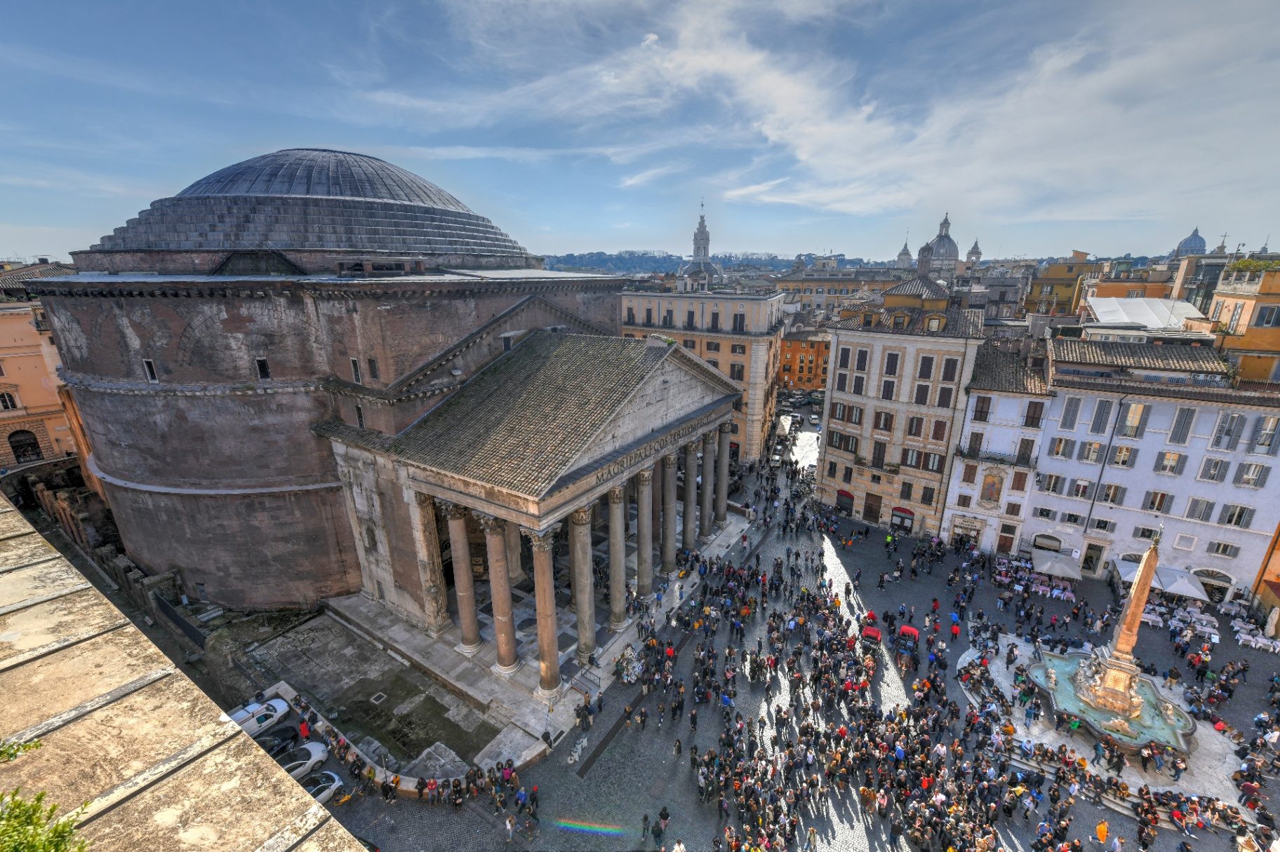 Rooftop view of the Pantheon's dome, portico and crowded Piazza della Rotonda with the Macuteo obelisk fountain