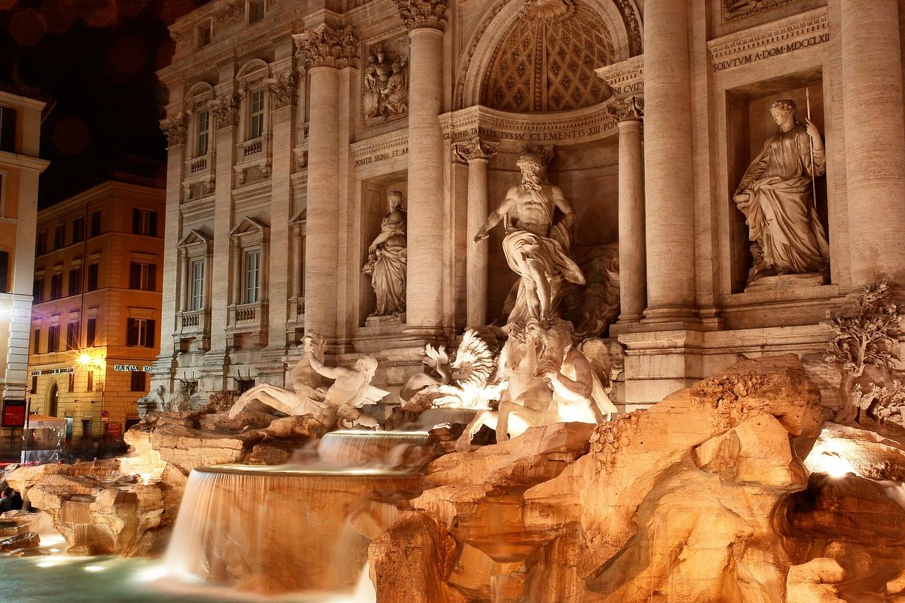 Trevi Fountain illuminated at night with golden lighting